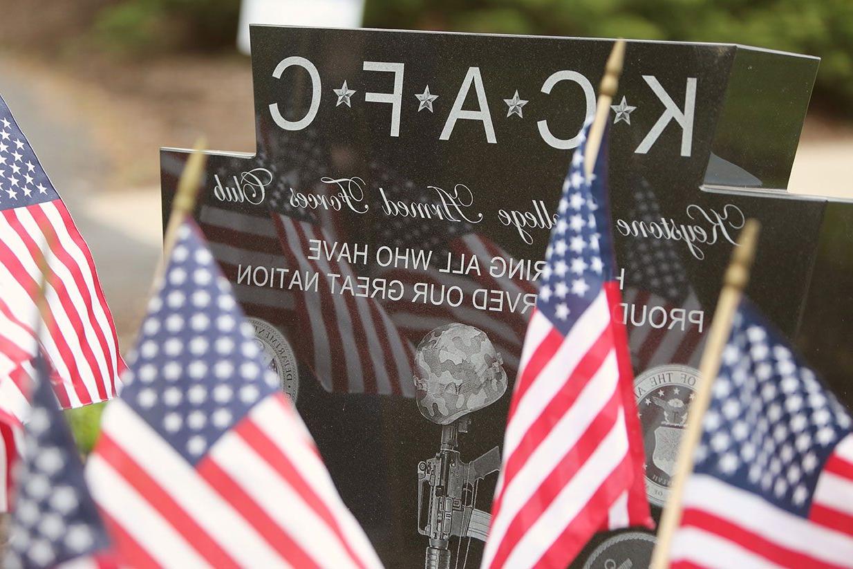 Flags surround the KCAFC memorial stone.